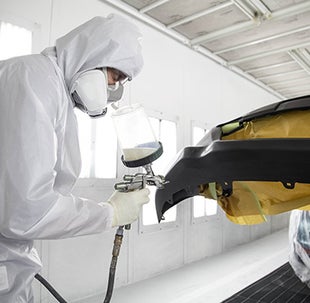 Collision Center Technician Painting a Vehicle | Mike Johnson's Hickory Toyota in Hickory NC